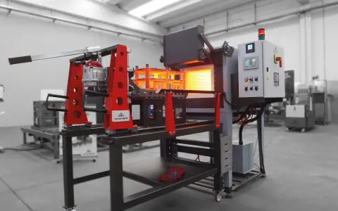 Macchina industriale per come temprare il ferro, con forno incandescente e pannello di controllo.