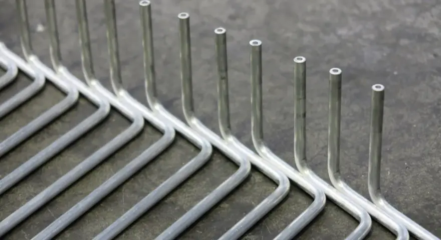 Tubi in acciaio inox piegati a formare un rastrello. La tecnica per come piegare un tubo in acciaio inox è fondamentale per ottenere queste forme precise.