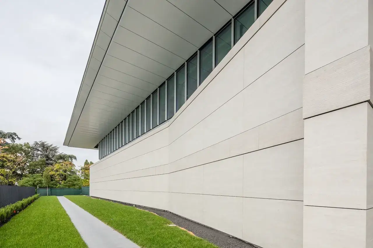 Rivestimento moderno per come coprire un muro esterno di cemento con pannelli chiari.